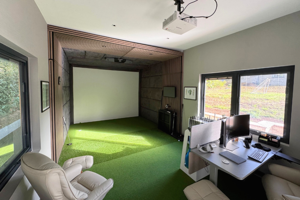 Foresight Golf Simulator in bespoke Garden Room with desk area, projector and seating.